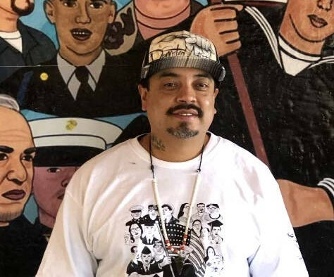 Color photograph of artist who calls himself "Deported Artist"